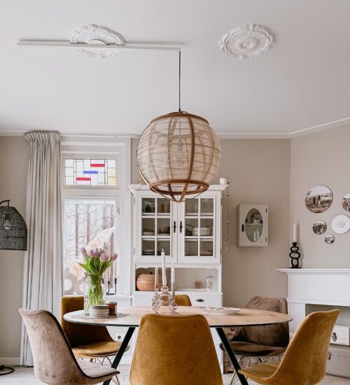 Lightswing and pendant lamp hanging from an ornament on the ceiling